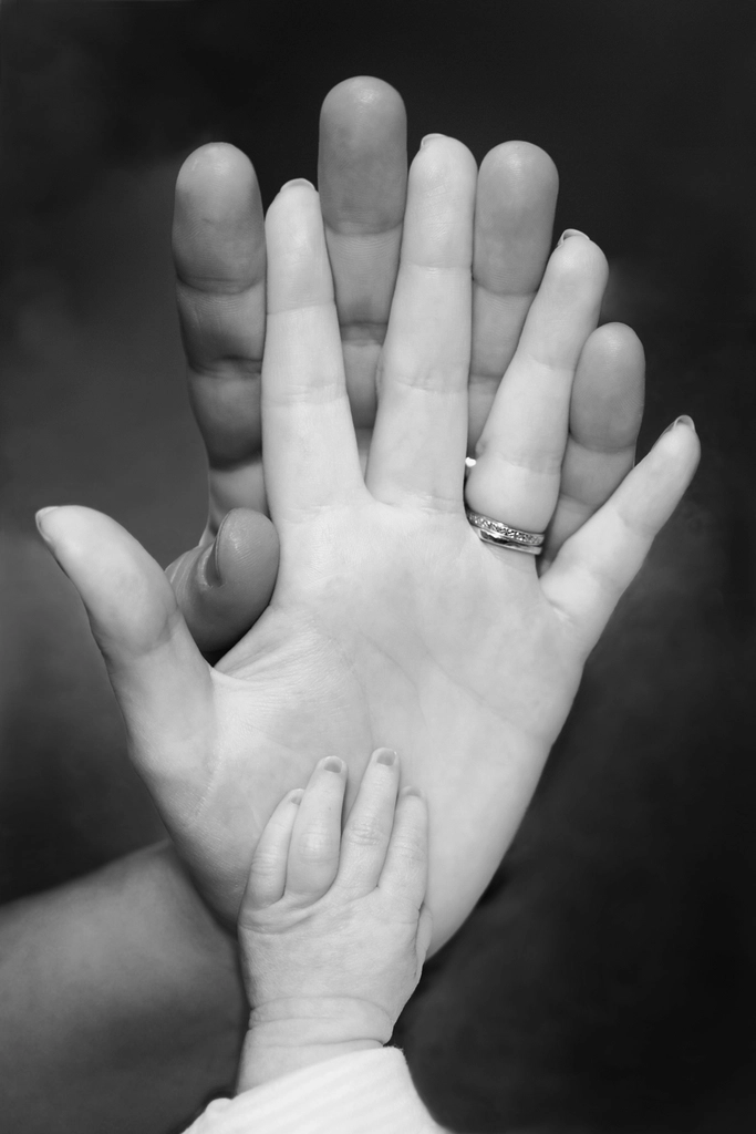 A parent's hand with a child's hand